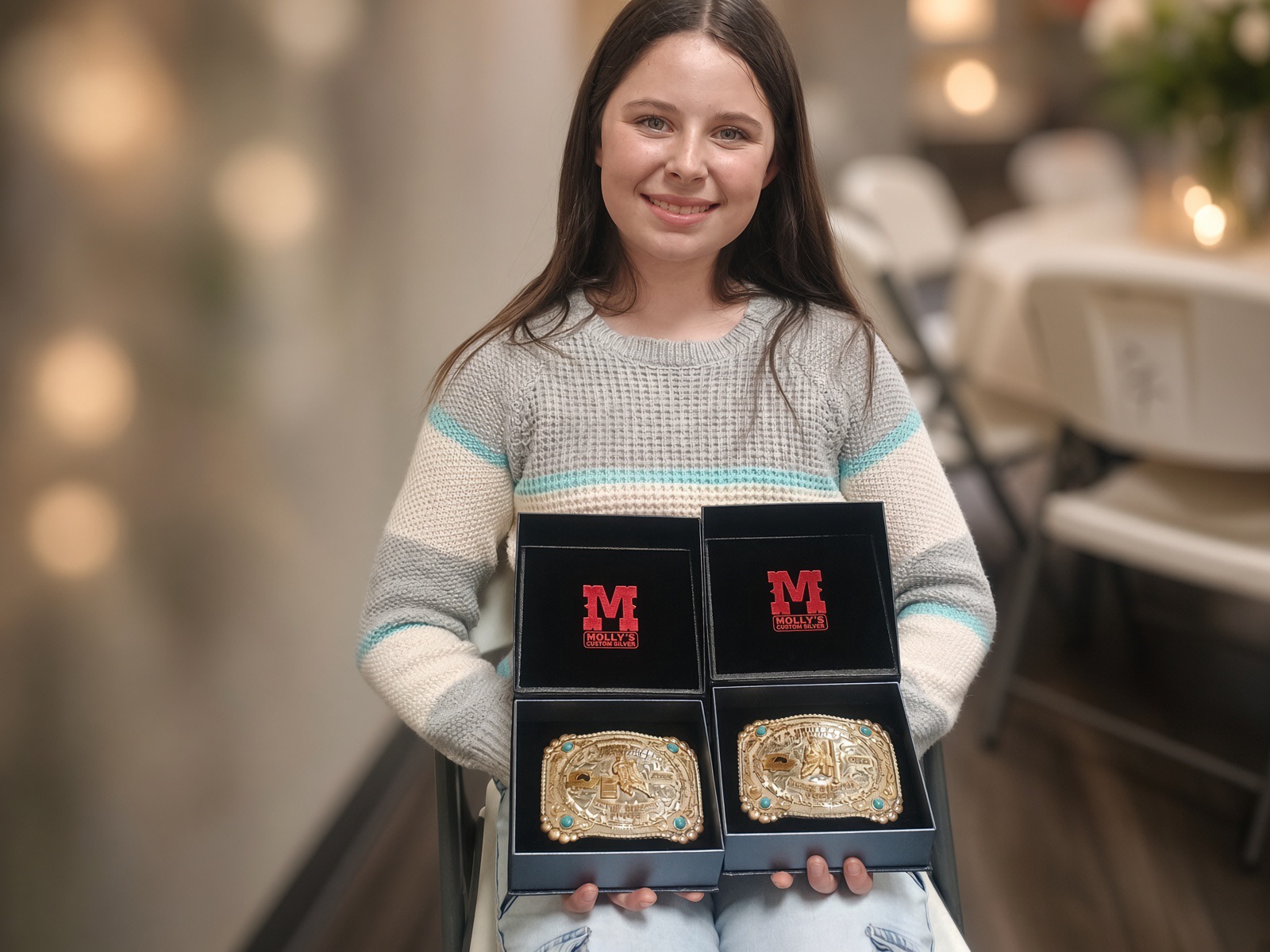 Emma proudly showing her two championship buckles